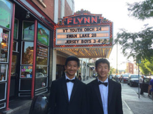 brothers in front of theater
